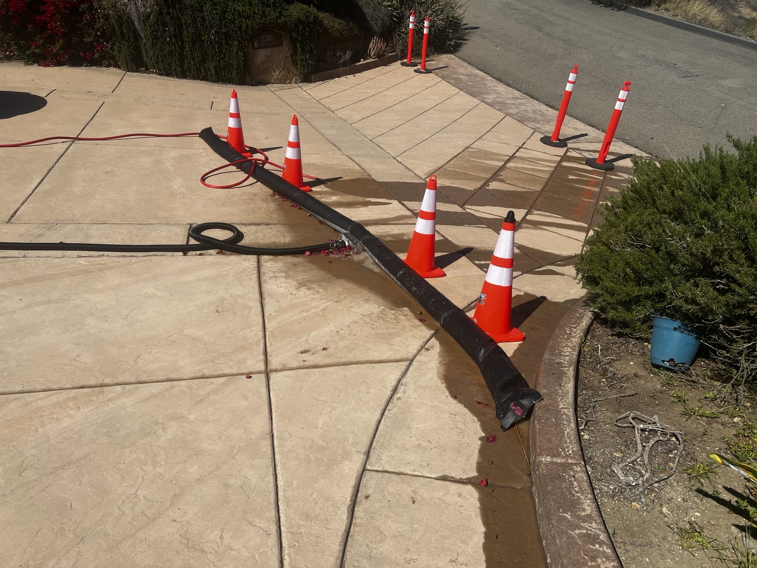 Driveway cleaning work area with safety cones