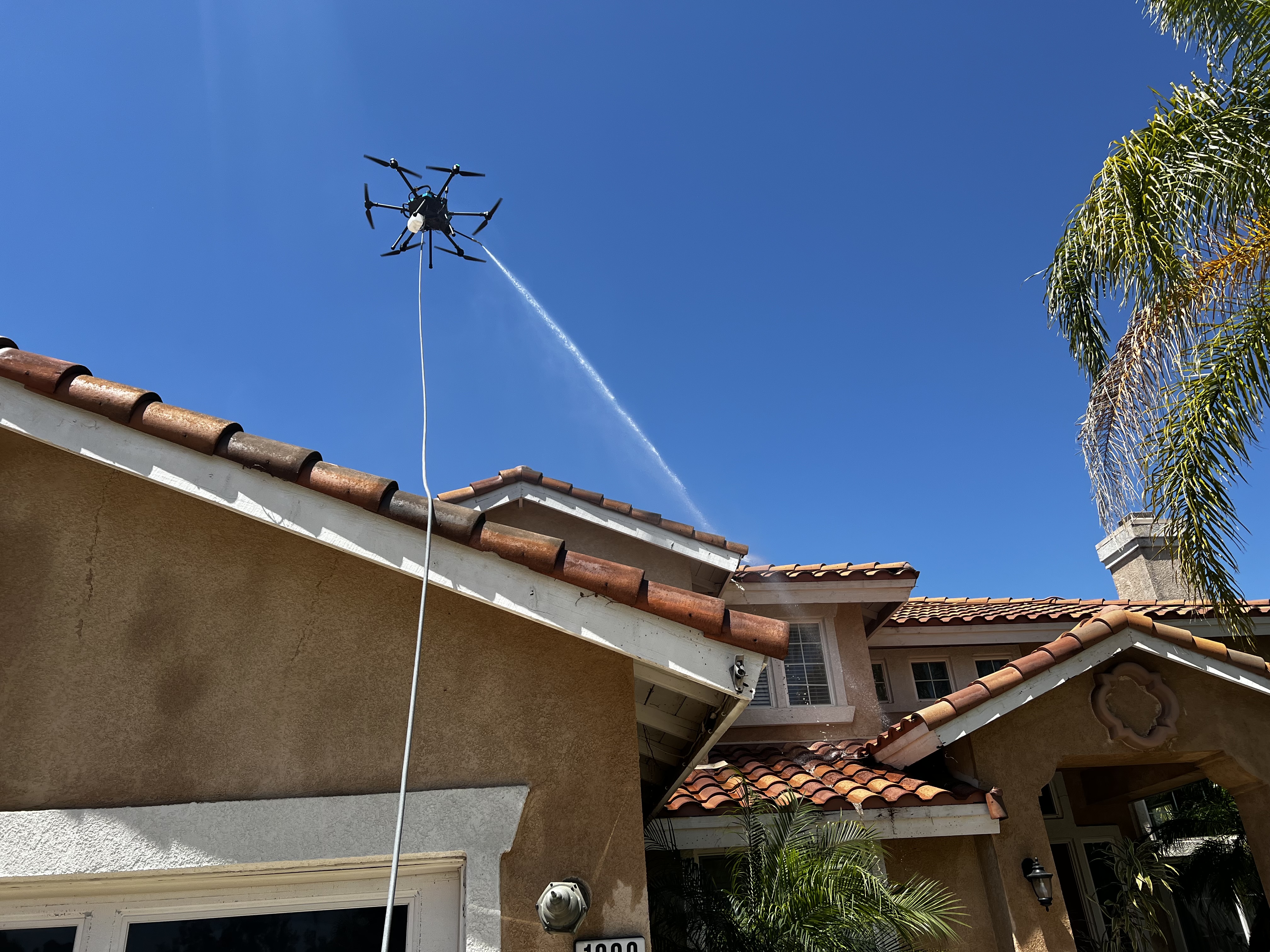 HoverWash drone cleaning a residential roof