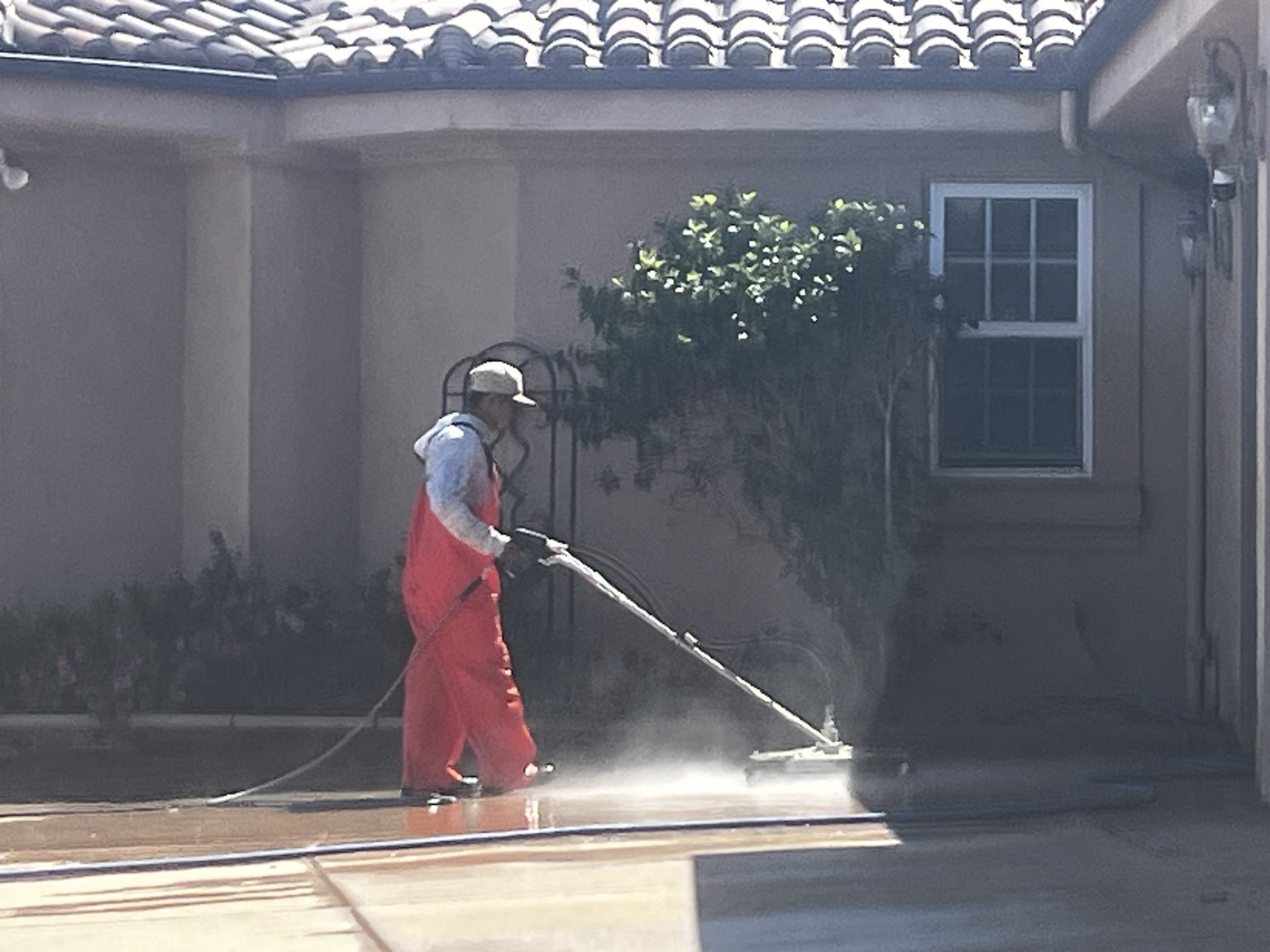 Surface cleaning a patio with pressure washing equipment